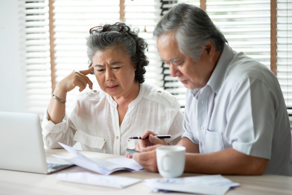  An older couple calculating their finances.